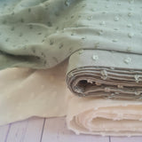 fabric with textured spots on - sage and cream colour