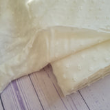 Viscose dobby textured spot polkadot dress fabric. Sage green and white